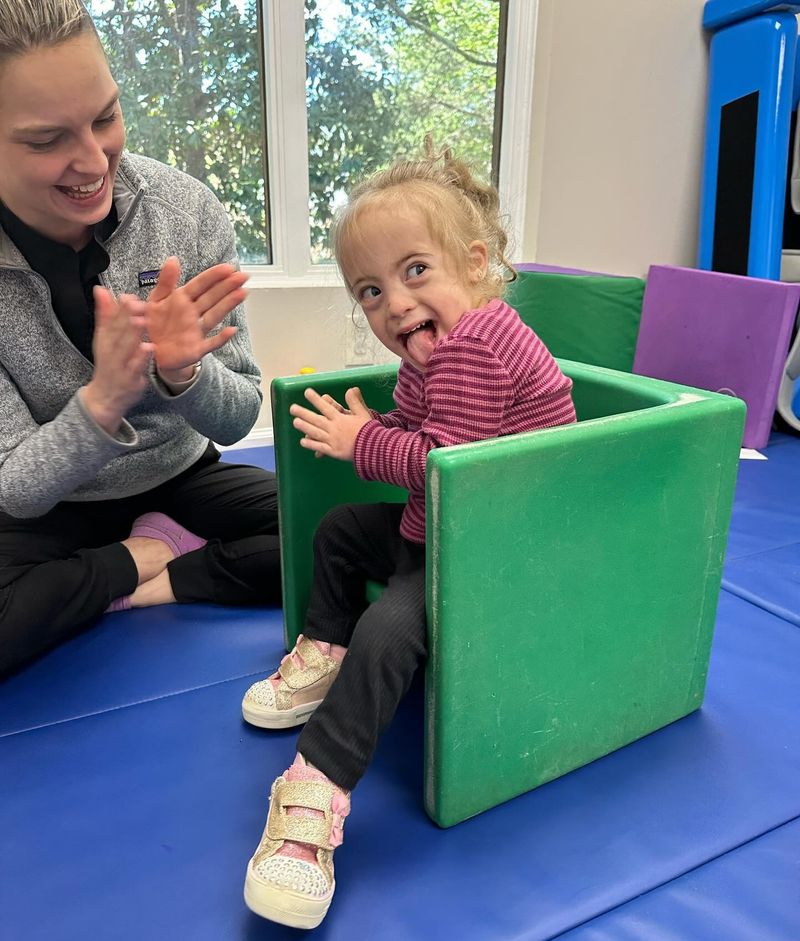 A girl playing with therapist as part of Occupational Therapy.